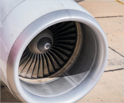 Close-up view of an aerospace airplane engine turbine with visible blades.
