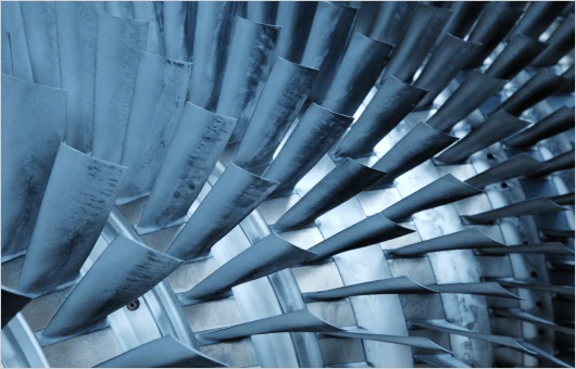Close-up of metal turbine blades arranged in a circular pattern.