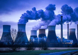 A power plant dedicated to power generation stands tall, its multiple cooling towers releasing streams of steam against the vibrant evening sky.
