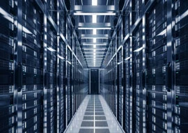 A long corridor in a data center with rows of server racks, overhead lighting, and the hum of HVAC technology ensuring optimal temperature control.