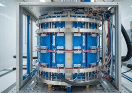 A complex piece of scientific technology featuring blue and silver cylindrical components and wires, all meticulously housed in a sleek metallic frame.