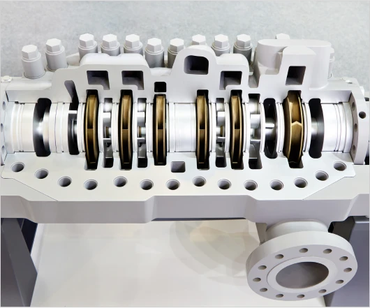 Cross-section of an industrial compressor, highlighting the intricacies of turbomachinery development with internal components like rotors, bearings, and casings.