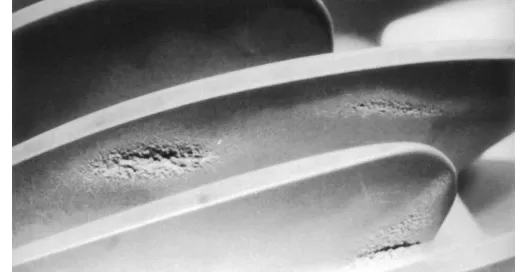 Close-up image of metal surfaces with visible pitting and corrosion marks.