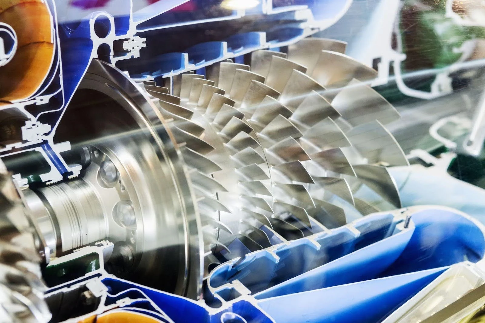 government-research-and-development-4 A close-up view of a turbine engine cross-section, revealing detailed metal blades and internal components, showcases the remarkable results of government research in advancing aerospace technology.
