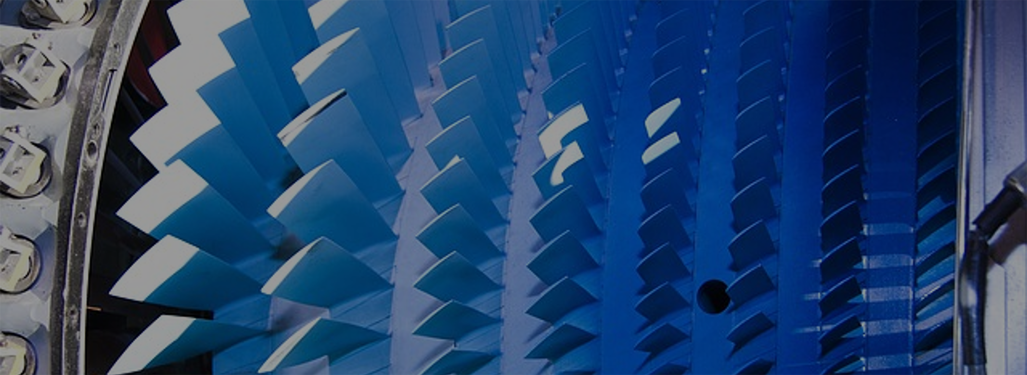Close-up of a turbine enhanced by AxStream technology, featuring multiple angled, blue metal blades arranged in a circular pattern.